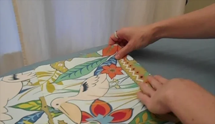 Measure 2 inches from the bottom seam of the back panel and pin a panel in place. Sew along the bottom 1/2 inch from the edge to secure.