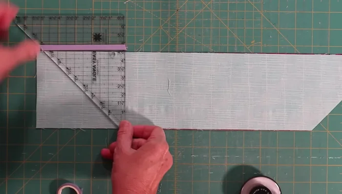Cut along the diagonal, flip the ruler, and cut again.