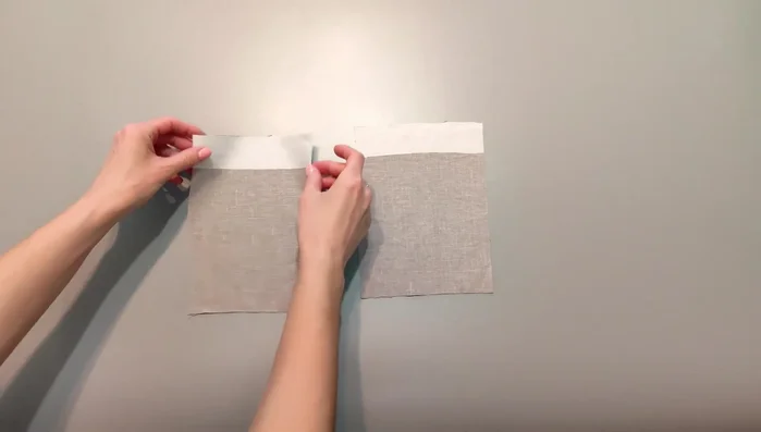 Prepare the pockets: Press the upper allowance of the pocket by 1cm and then by 3cm. Stitch the upper corners, fold allowances over, stitch, turn right side out, and press. Top stitch the pressed upper seam.