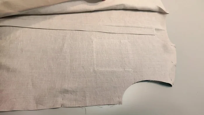 Sew the front and back pieces: Place the two front pieces onto the back. Stitch and overlock the shoulder and side seams. Press seam allowances to the back.