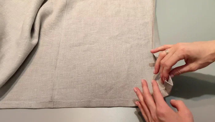 Prepare the placket: Stitch the bottom corner of the placket along the hemline, fold to the right side, and stitch along the pressed hemline. Turn out and press. Top stitch the bottom of the shirt.