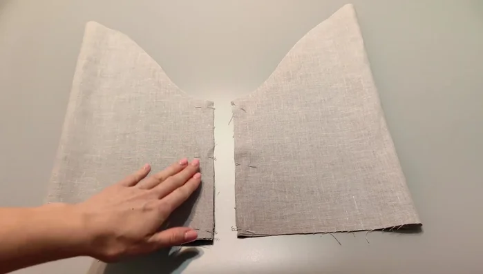 Sew the sleeves: Stitch the sleeves along the edges and overlock them. Press seam allowances to the back. Press the bottom of the sleeves. Top stitch.