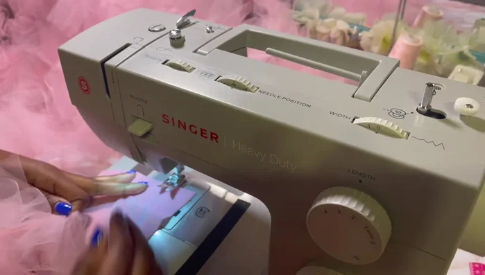 Attach the tulle ruffles to the skirt. Place the ruffles on the marked lines and sew along the center of the ruffles, directly above your initial stitching.