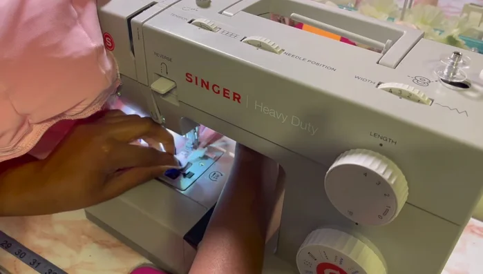 Hand sew a row of ruffles on top of the skirt seam.