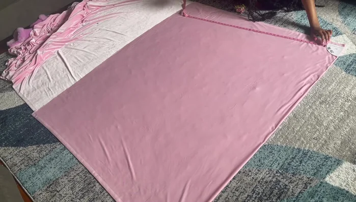 Create a sewing guide on your machine using tape. Pleat the tulle strips by hand. Sew the pleated tulle strips together, creating one continuous strip.