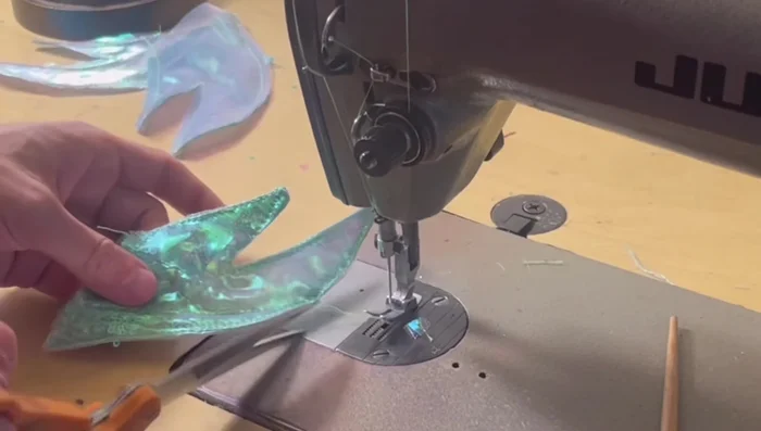 Assemble the tail: Sew outside fins to the top of the main tail piece. Attach front and back bottom fins separately.