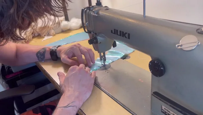 Iron and sew fabric layers together to prevent slippage.