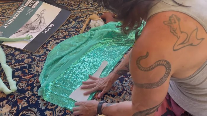 Prepare the tail fabrics: Layer sequin and iridescent fabrics. Cut iridescent fabric on the bias and add a layer of stiff interfacing for body.