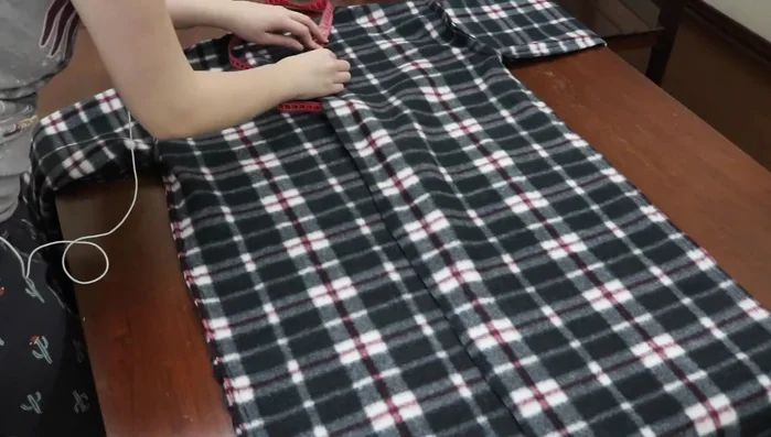 Fold the stripe in half; Pin and sew to the front opening and neckline.