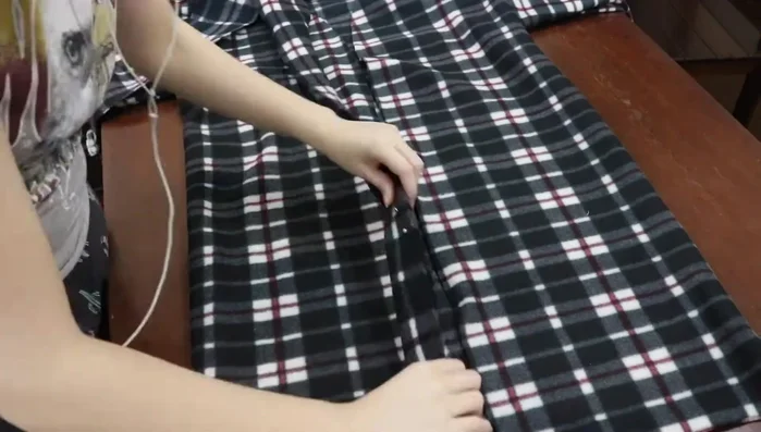 Fold the stripe in half; Pin and sew to the front opening and neckline.