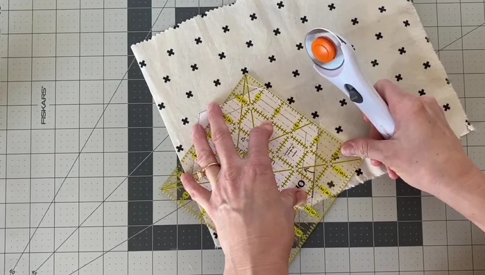 Cut out three hexagons for each coaster: one top fabric, one bottom fabric, and one fusible fleece.