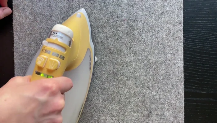 Fold the fabric inside the coaster at the gap to create a seam. Press the seam.