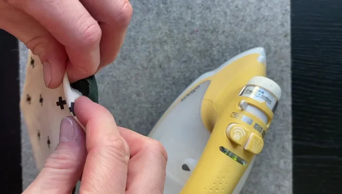 Fold the fabric inside the coaster at the gap to create a seam. Press the seam.