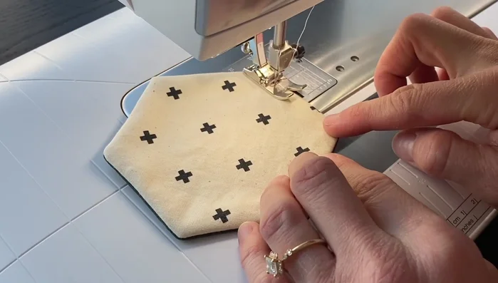 Top stitch around the entire edge of the coaster about ⅛ inch from the edge, backstitching at the beginning and end to close the opening and secure the layers.