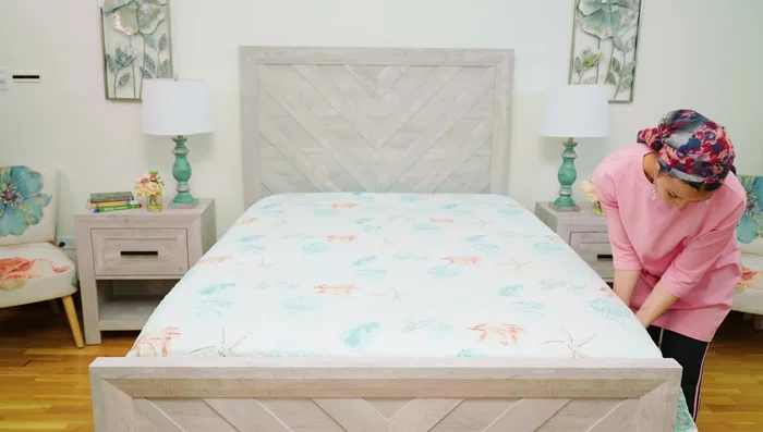 Tuck the bed covering under the mattress at the foot. Choose between tucking in all sides for a crisp look (using hospital corners) or leaving it untucked for a more casual look.