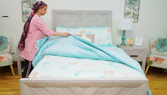 Lay the blanket over the bed, optionally folding it in half or thirds.