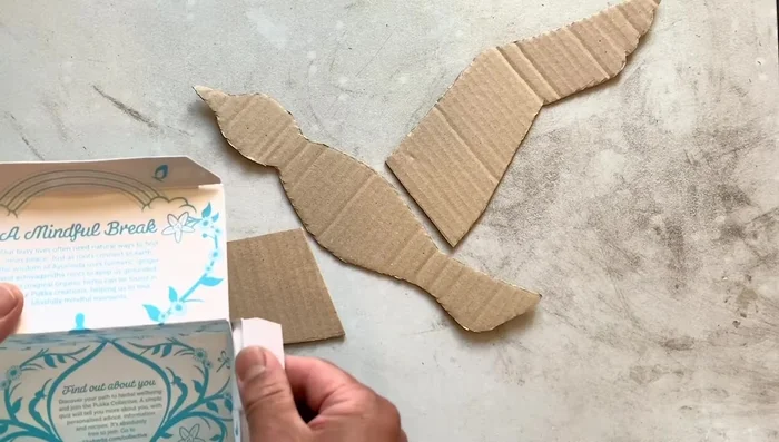 Attach the wing hinges to the bird's body, ensuring symmetry.