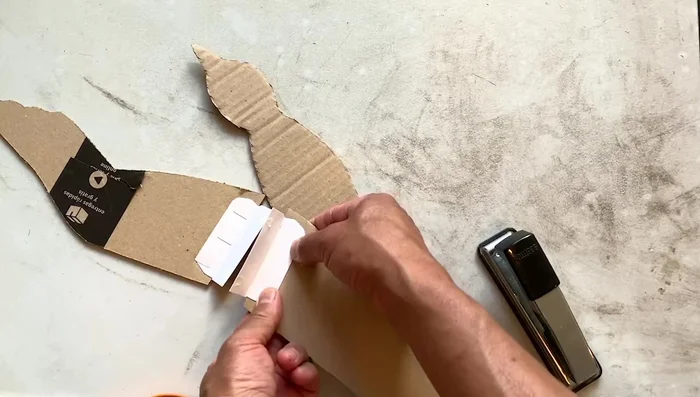 Attach the wing hinges to the bird's body, ensuring symmetry.