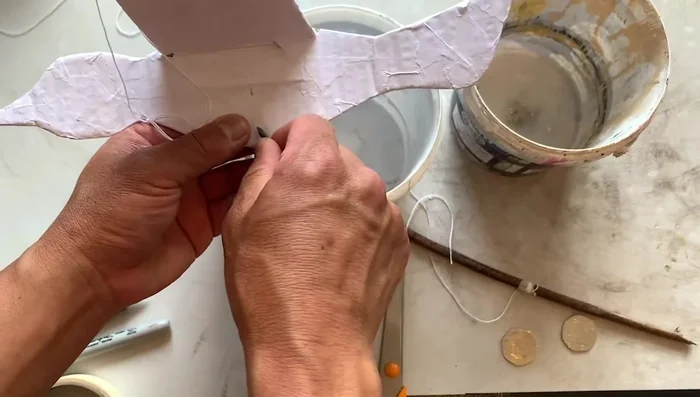 Decorate the bird using paint, colored paper, markers, or colored pencils. (The video shows an example using markers and colored pencils to decorate the bird.)
