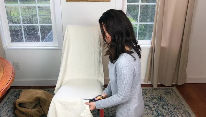 Cut around the pinned fabric, leaving an inch or two of overhang.