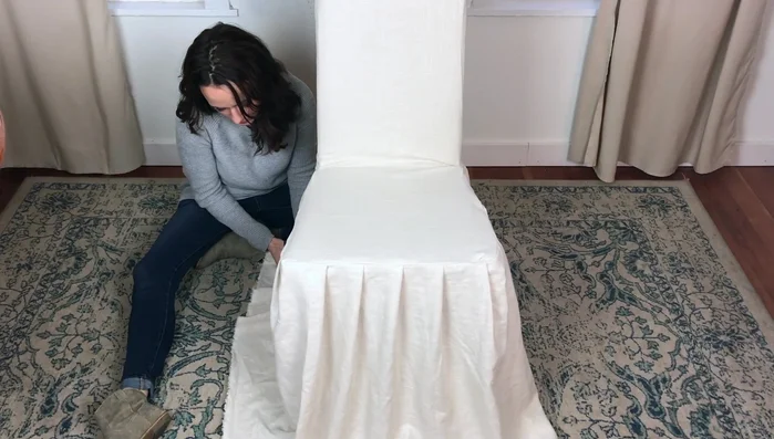 Open up the side hems of the ruffle for a flatter look, fold up the desired hem width, iron, and sew with a wide, loose stitch.