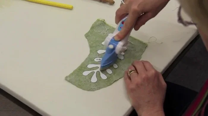 Clip the curves of the fabric, staying about 1/8 inch away from the freezer paper to prevent raw edges.