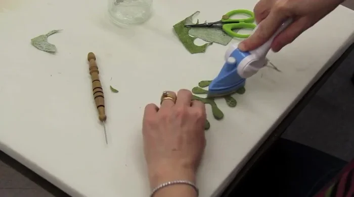 Apply glue dots to the back of the appliqué and position it onto the quilt.