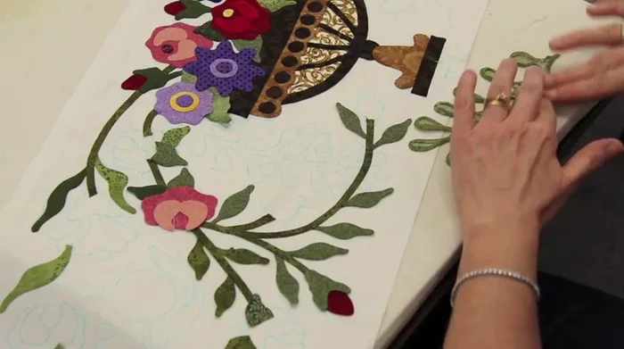 Apply glue dots to the back of the appliqué and position it onto the quilt.