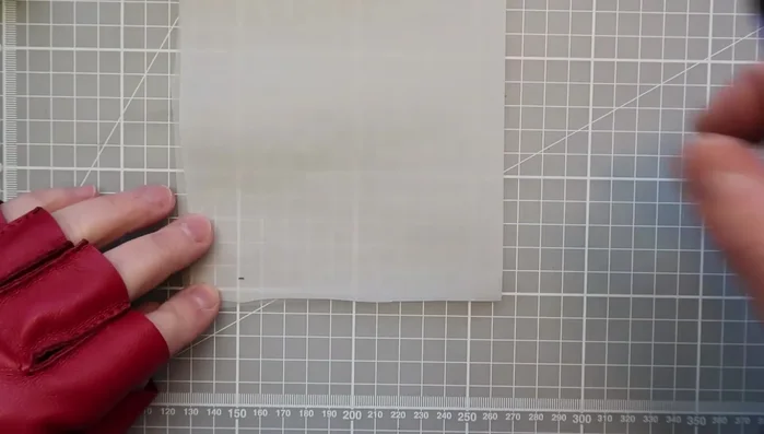 Align the base of your fingers and the glove base with the horizontal line drawn on the tracing paper, and transfer the lines onto your template.