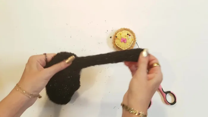 Create the neck: Using a running stitch, sew around the neck area of the sock to define the head and neck.