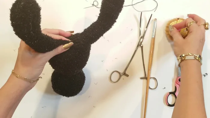Close the leg openings: Using a ladder stitch, close the leg openings.