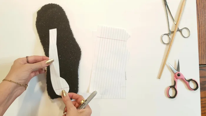 Attach limbs, tail, and ears: Pin the limbs, tail, and ears into place. Whip stitch to secure them.