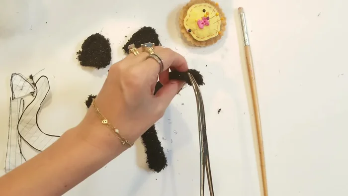 Attach limbs, tail, and ears: Pin the limbs, tail, and ears into place. Whip stitch to secure them.