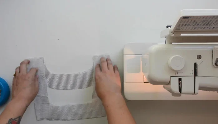 Press outer edge of facing under 1/4 inch, using the previous stitch as a guide.