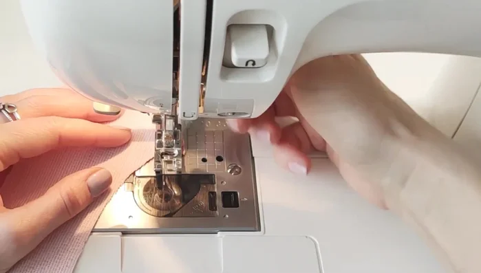 Attach the facing to the neckline. Stitch, clip curves, and topstitch.