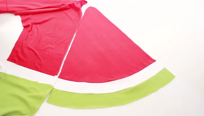 Create the side pieces. Line up the colors of the fabric with a triangle and cut out two side pieces to match the main slice piece.