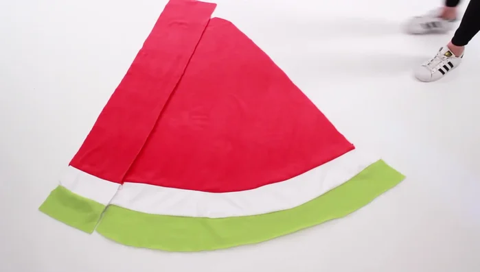 Sew the side pieces to the main slice. Sew the two side pieces onto the main watermelon slice.