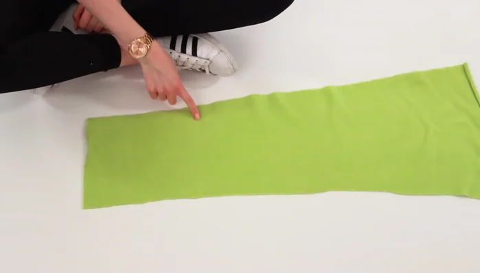 Design and cut out the facial details on paper, then transfer them onto black and pink fabric and cut out the fabric pieces.