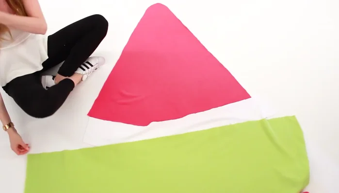 Create the side pieces. Line up the colors of the fabric with a triangle and cut out two side pieces to match the main slice piece.