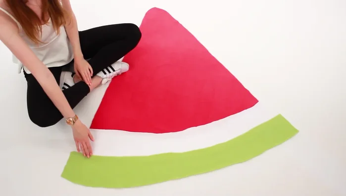 Sew the side pieces to the main slice. Sew the two side pieces onto the main watermelon slice.
