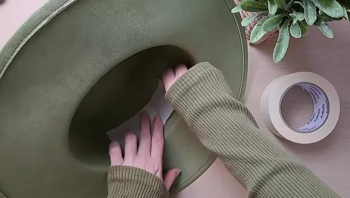 Apply masking tape to the edge of the brim to protect it from glue.