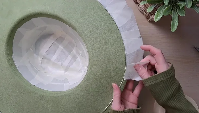 Apply masking tape to the edge of the brim to protect it from glue.