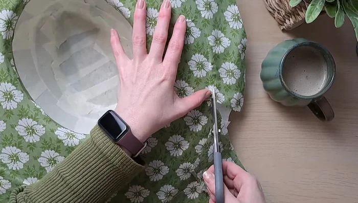 Trim the excess fabric, being careful not to cut into the stitching. Tuck the remaining fabric under the stitching.