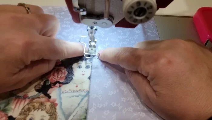 Sew Bag Pieces: Sew the pocket and tab onto the lining. Place the outer and lining pieces together with right sides facing, lining up the bottom edges and side seams. Sew around the bottom.