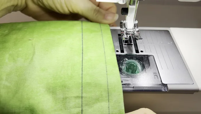 Sew two additional lines along the top edge of the bag to create the casings for the drawstrings, using 0.25-inch seam allowance.