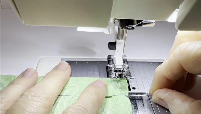 Sew the main fabric pieces together, using a 0.25-inch seam allowance. Remember to leave the openings for the drawstring gaps unsewn.