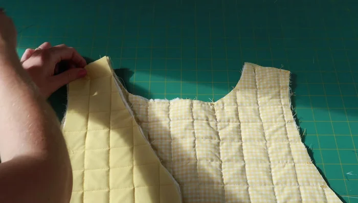 Sew bias tape along shoulder seams.