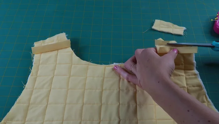 Sew bias tape along shoulder seams.