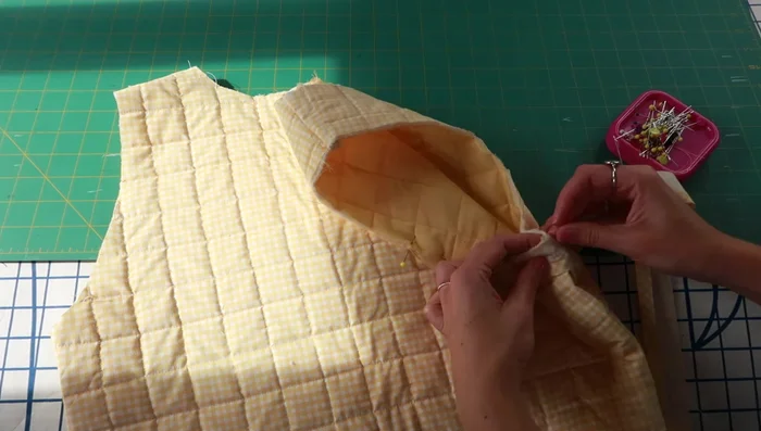 Attach bias tape around armholes, stitching in the ditch.