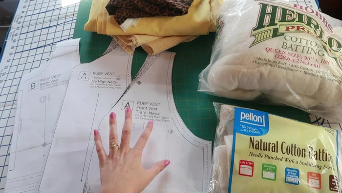 Cut out pattern pieces for both vests (V-neck and high-neck variations).